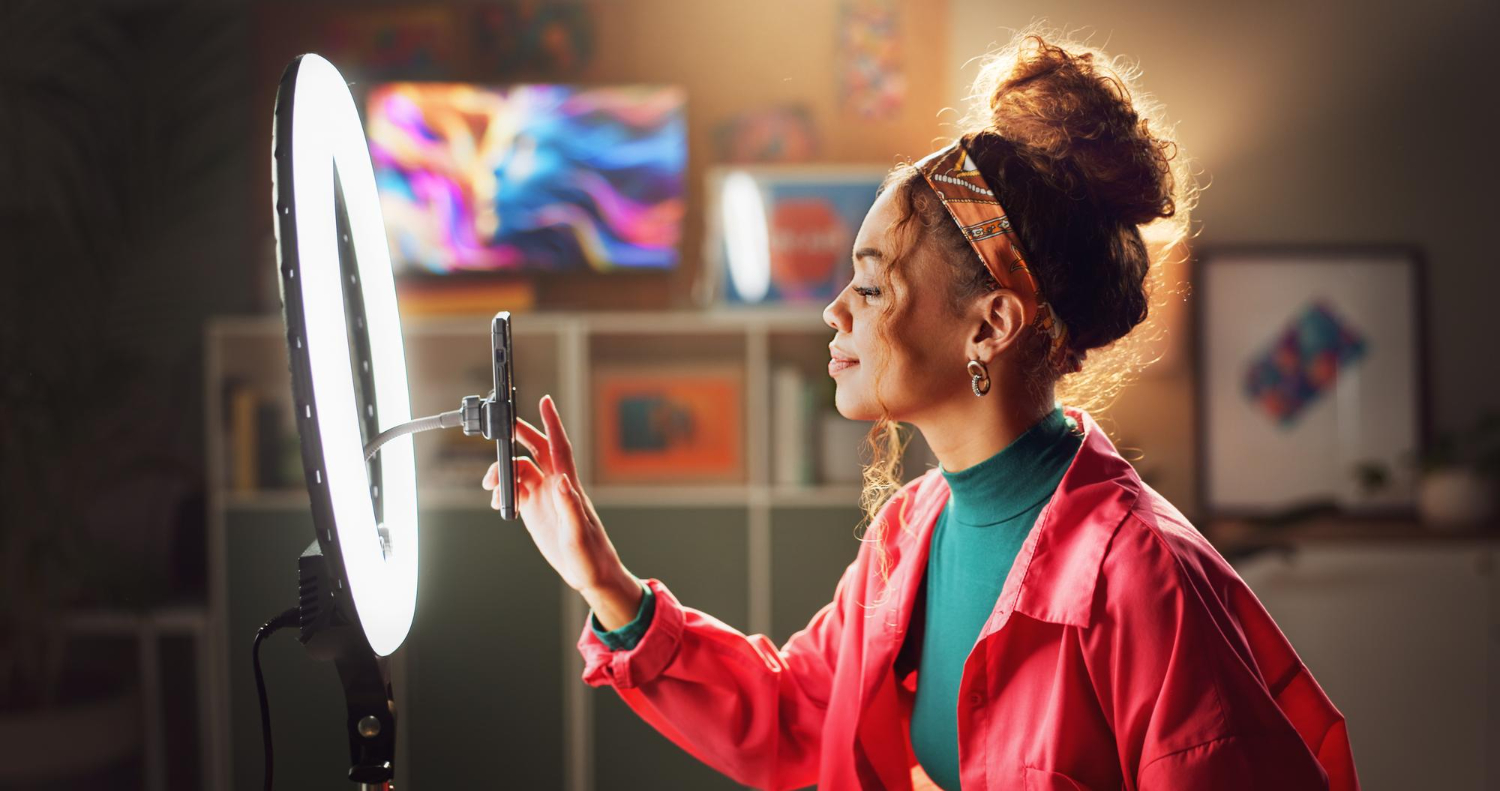 Content creator with ring light and smartphone